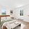 spacious bedroom with bright windows