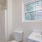 window in bathroom with shower and ample lighting