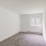 ac unit in carpetd bedroom with natural lighting from window