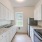 galley style kitchen with natural lighting pouring through window